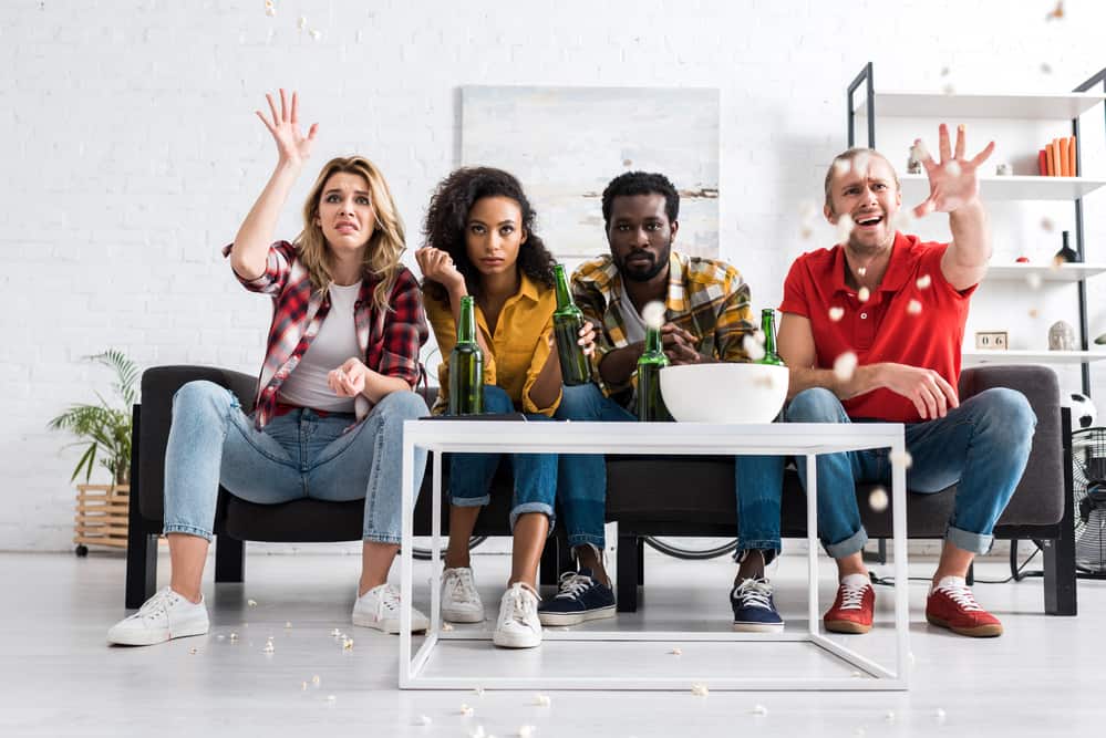 four people watching a movie in a wireless home theater